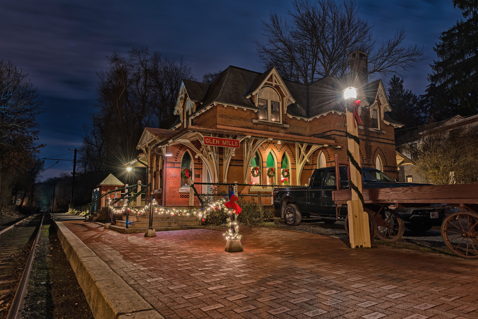 Historic train station with Christmas lights at night.